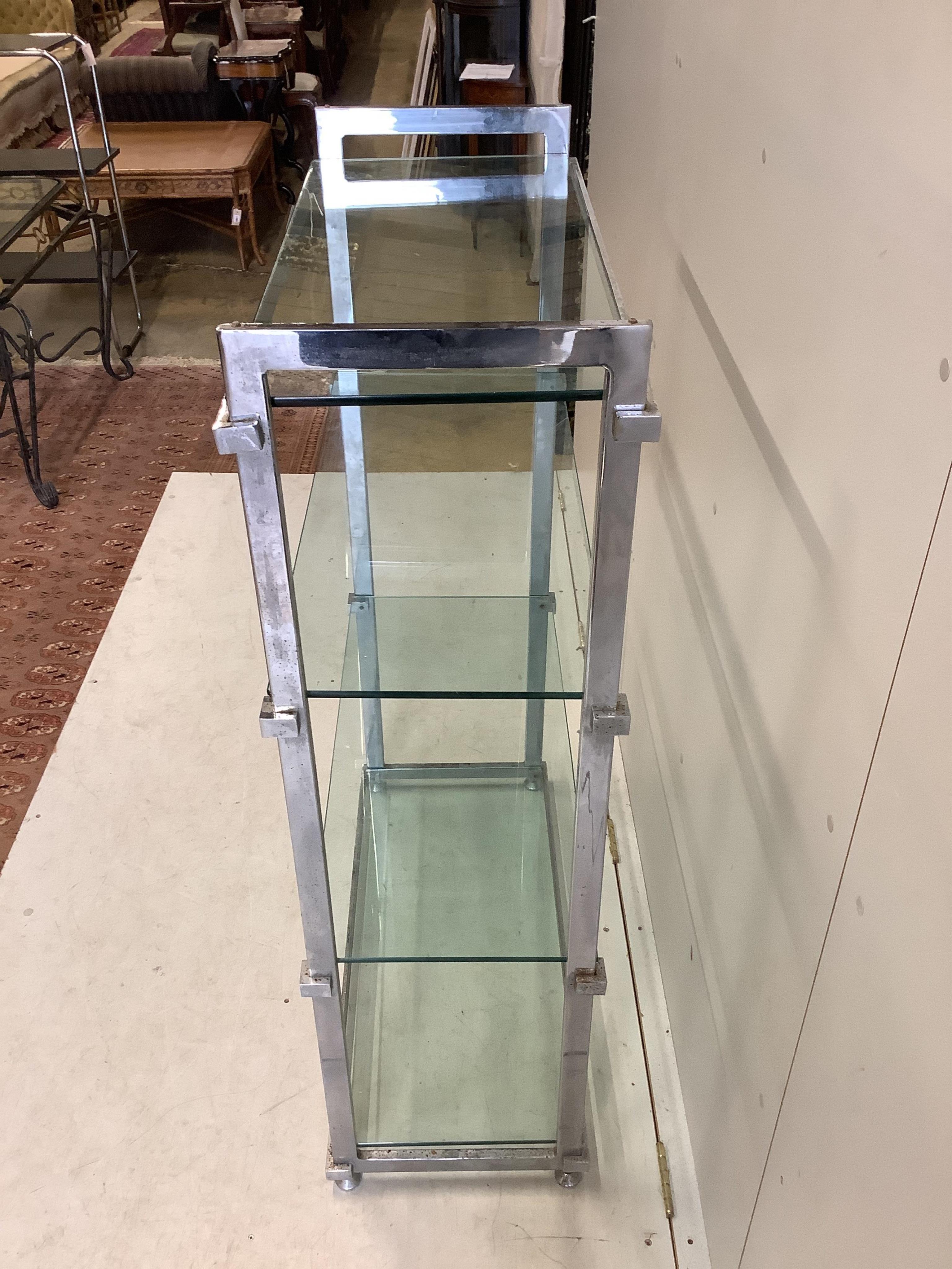 A chrome and glass four tier shelf unit, width 86cm, depth 38cm, height 130cm. Condition - fair